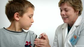 Ärzten impft einen Jungen